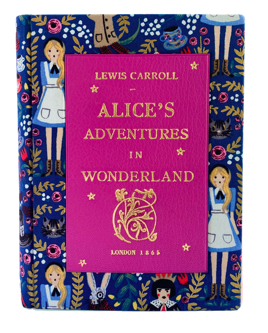 A pink leather book- clutch cover with a printed Alice fabric featuring illustrations of characters and flowers, and the text 'Alice's Adventures in Wonderland' by Lewis Carroll.